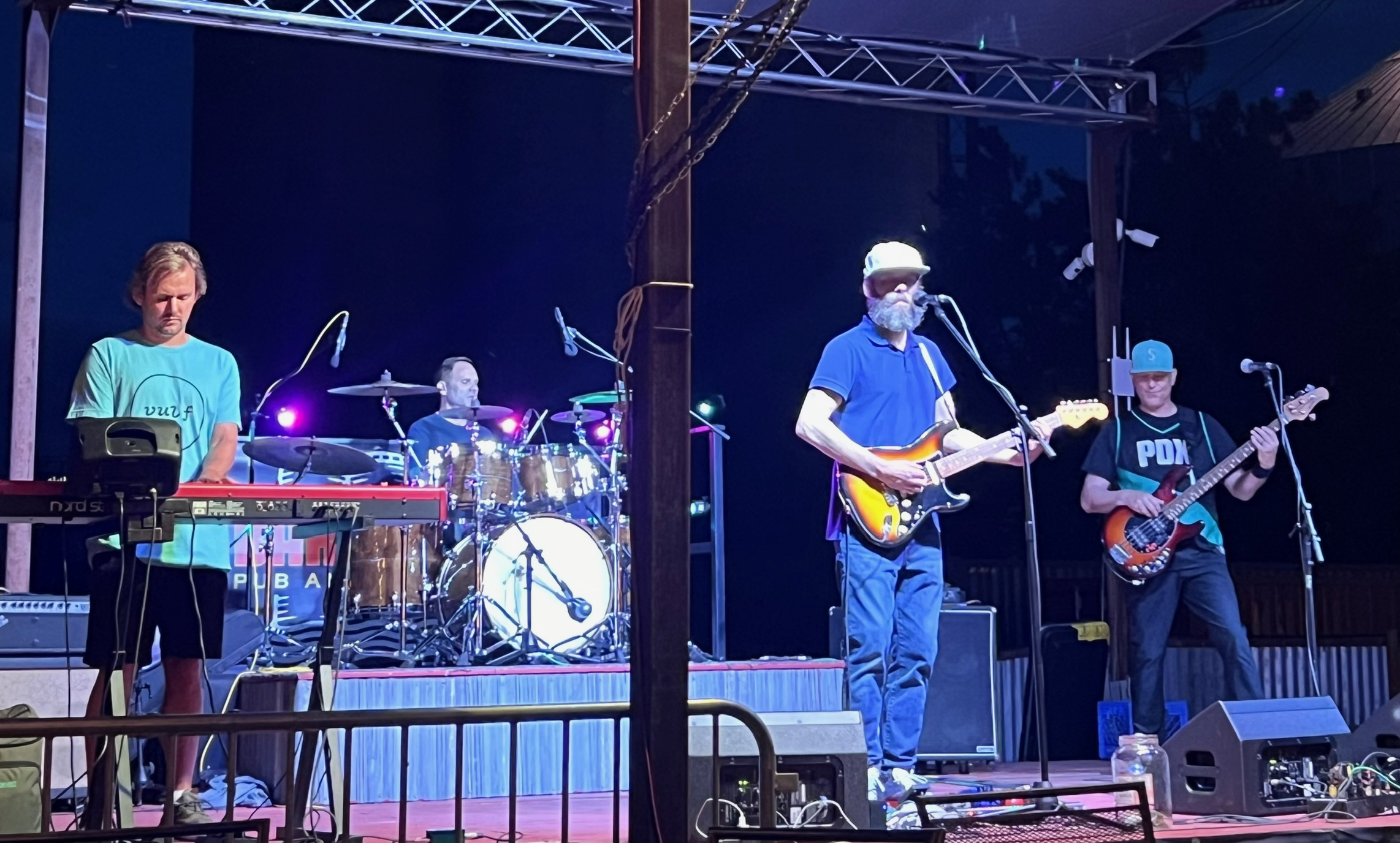 The West Goats performing under stage lights at night on an outdoor stage